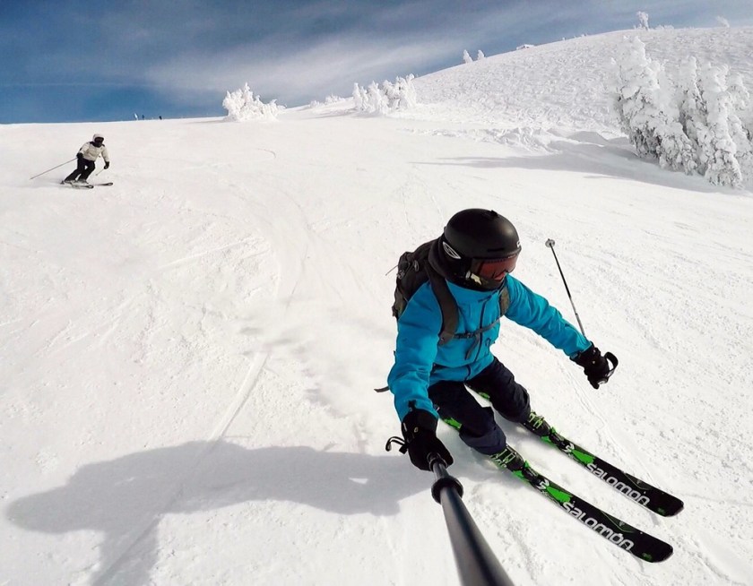 two skiers ripping groomers