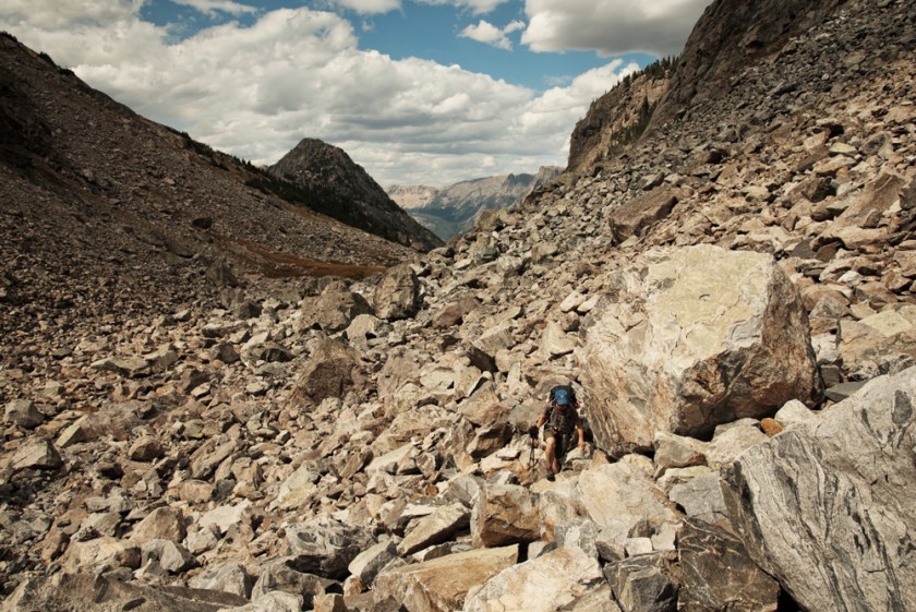 Scrambling over boulders to reach Shannon Pass while backpacking the Wind River Range in Wyoming