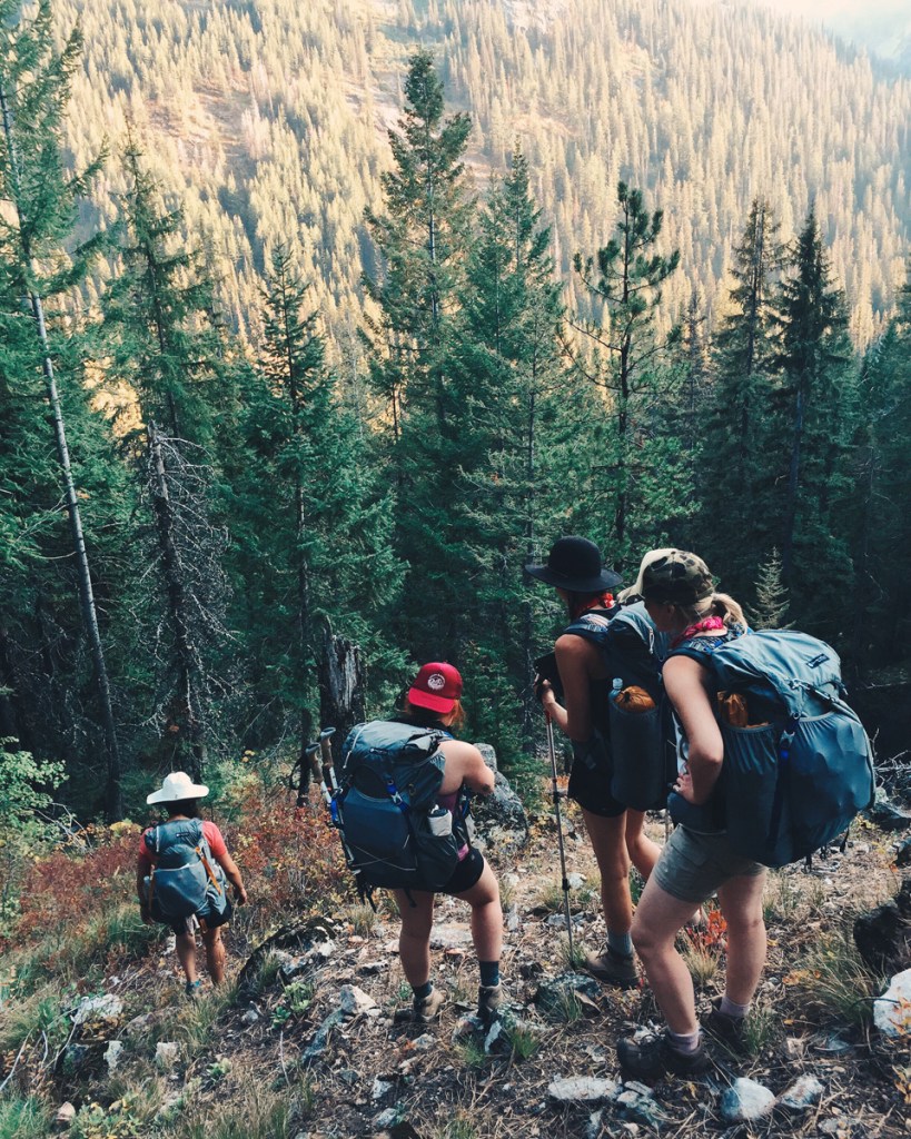 Women backpacking through rugged wilderness